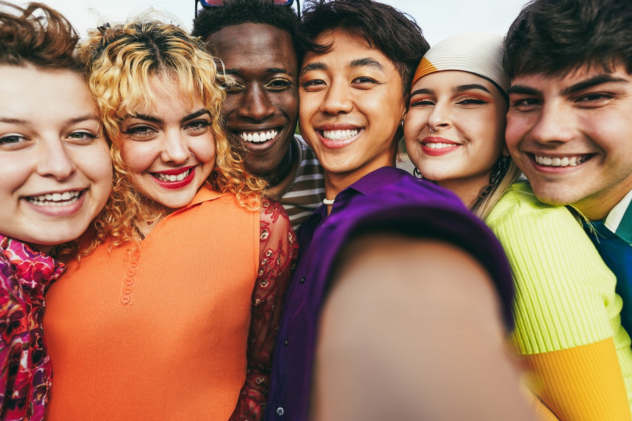 Young diverse friends having fun doing selfie outdoor