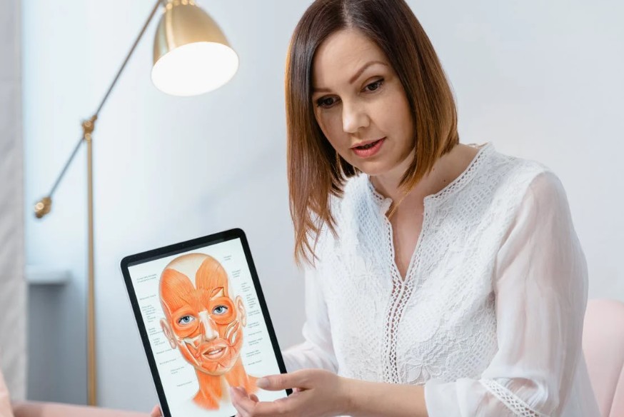 A dermatologist holding an ipad