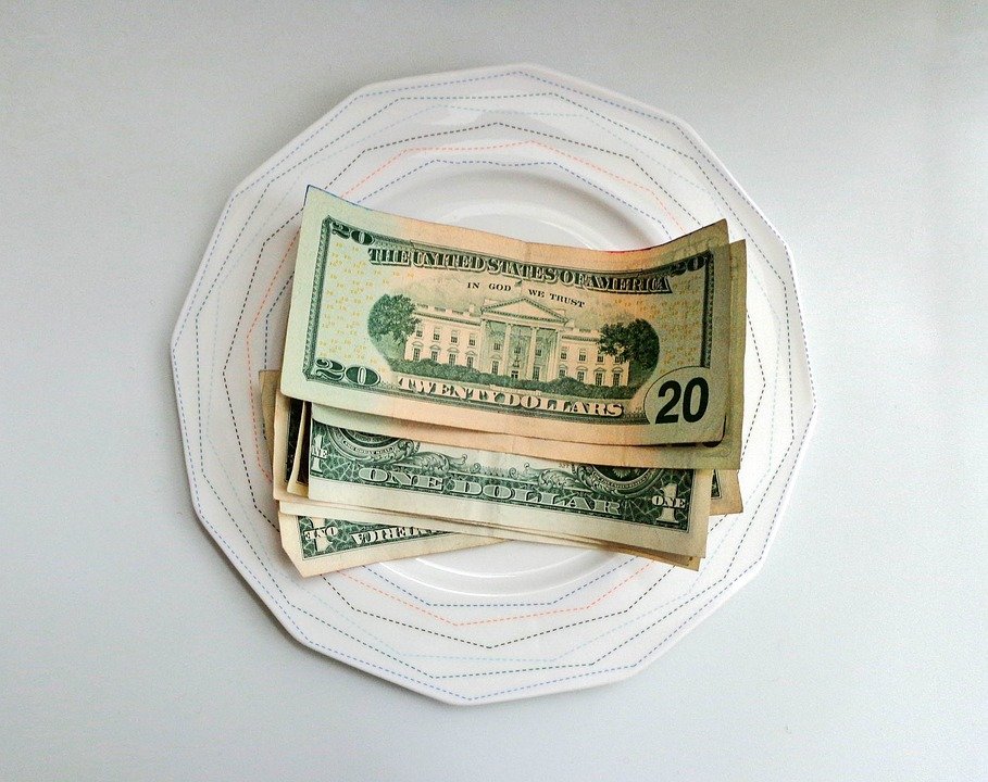Tip money on a plate