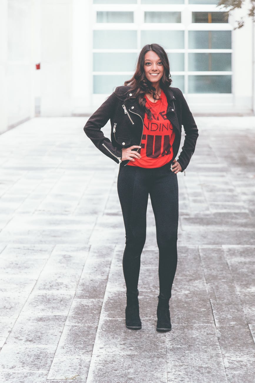 Woman wearing a red statement T-shirt with black leather jacket and black skinny jeans