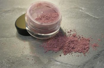 A jar of loose mineral eyeshadow powder