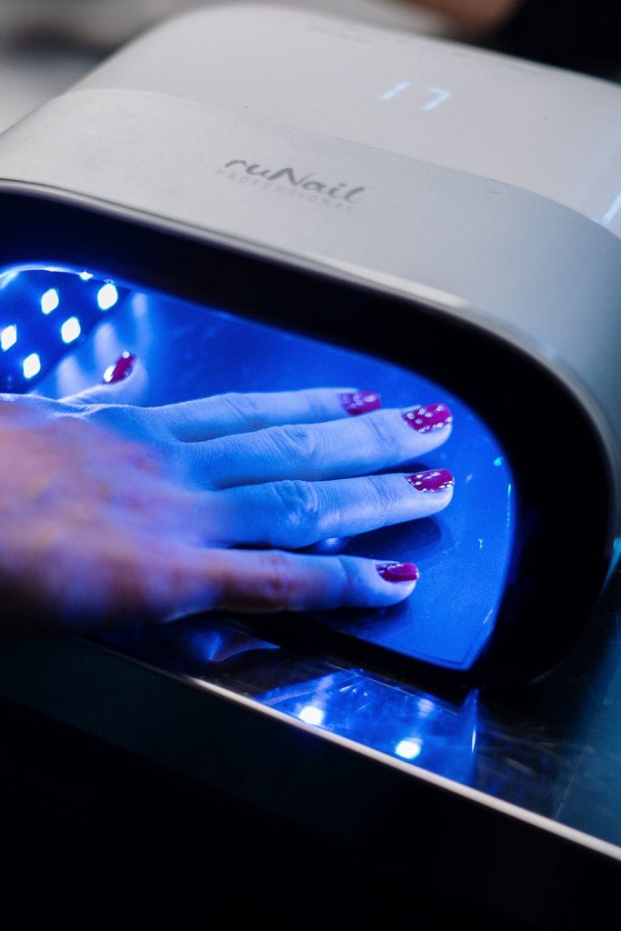 gel nails curing under UV light
