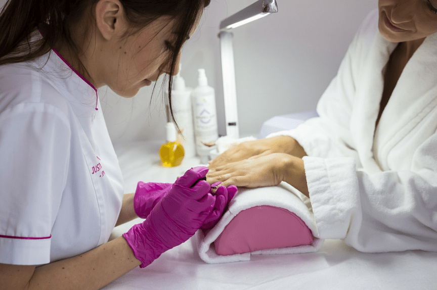 manicurist working on a client’s nails