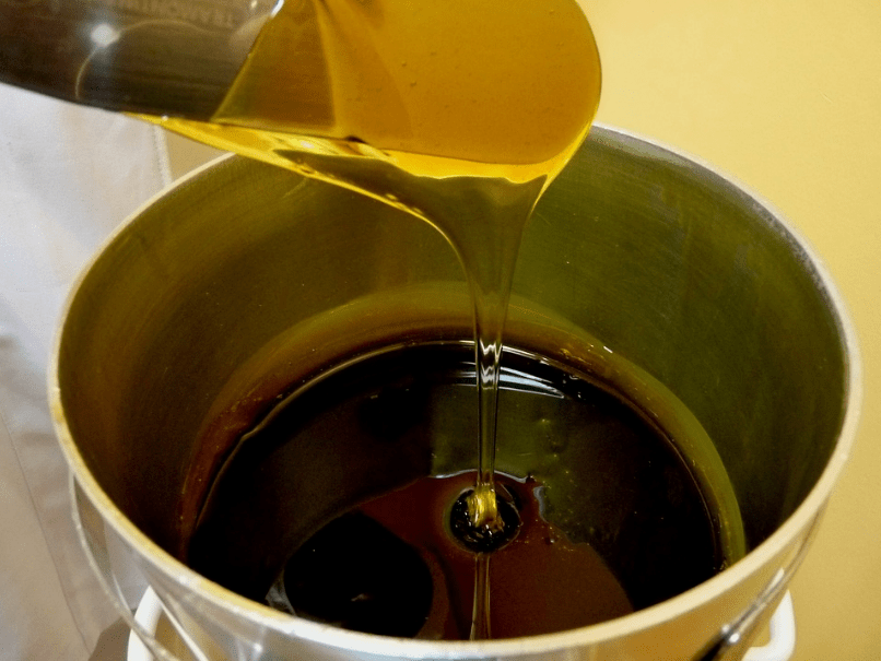 a container of wax, wax dripping