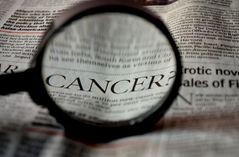 Cancer written on newspaper