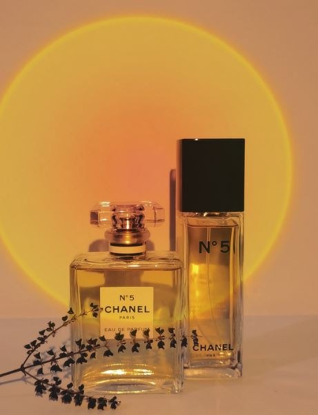 Chanel No, 5 perfume bottles, dried plant, sunset lighting