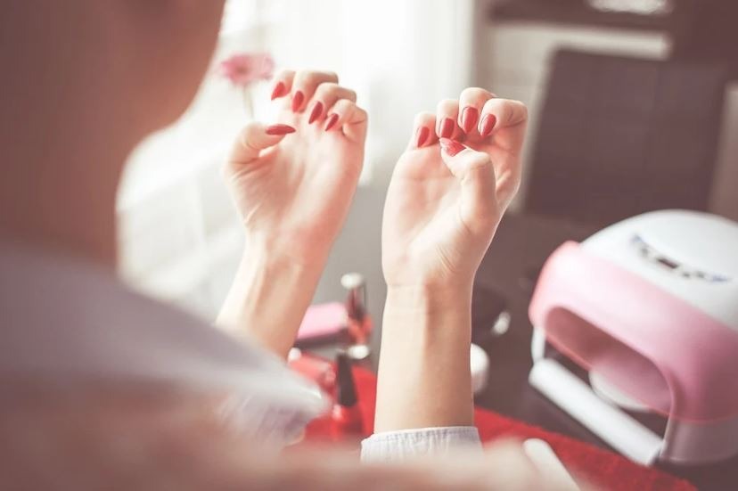 a woman looking at her manicured nails, nail kit