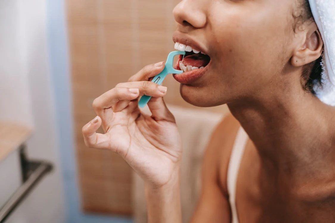 Woman flossing her teeth