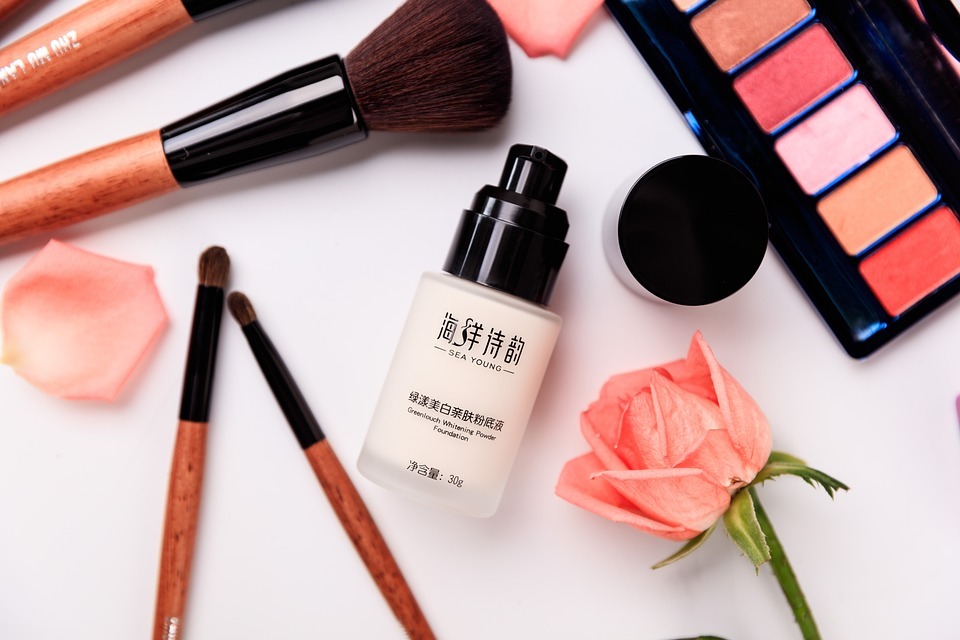a bottle of liquid foundation lying amongst other makeup products 